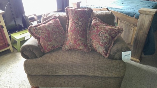 Oversized brown chair with paisley pillows